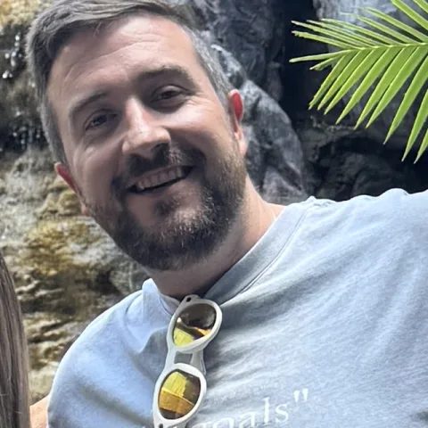 Andy Bedell, smiling outdoors